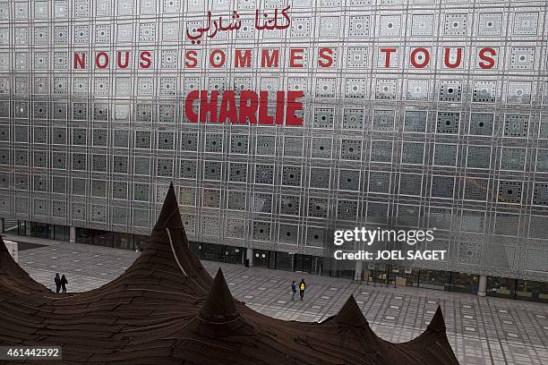 Slogan reading "Nous sommes tous Charlie" in Arabic and French has been put on the facade of the Institute of the Arab World in Paris, on January 12...