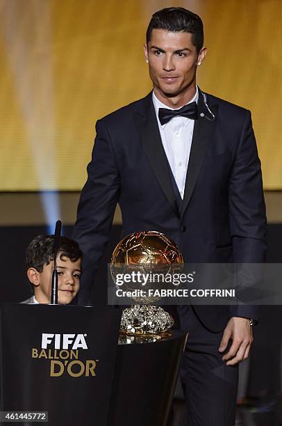 Real Madrid and Portugal forward Cristiano Ronaldo stands with his son Cristiano Jr after receiving the 2014 FIFA Ballon d'Or award for player of the...