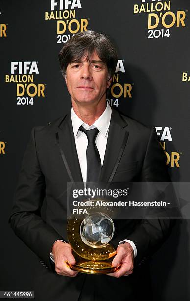World Coach of the Year for Men's Football winner Joachim Loew of Germany poses with his award during the FIFA Ballon d'Or Gala 2014 at the...