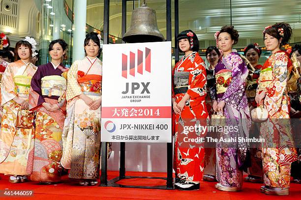 Employees wearing kimono pose for photos after the opening ceremony of the first trading day of the year at Tokyo Stock Exchange on January 6, 2014...