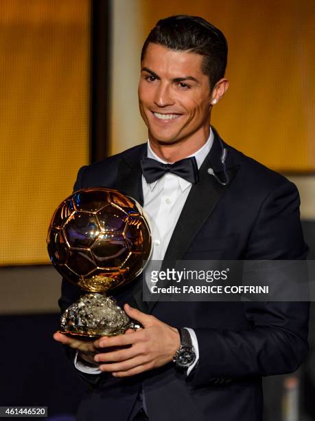 Real Madrid and Portugal forward Cristiano Ronaldo smiles after receiving the 2014 FIFA Ballon d'Or award for player of the year during the FIFA...