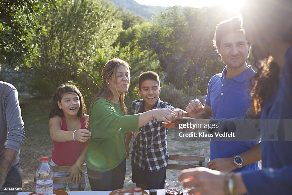 Multigenerational family eating olives outside