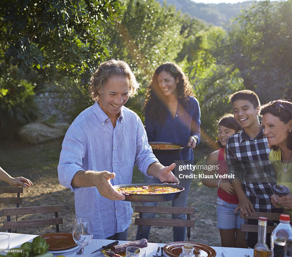 Multigenerational family setting dinner table