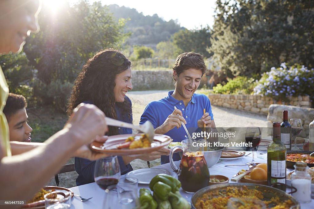 Multigenerational family laughing at dinner