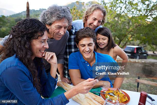 multigenerational family looking at video on phone - pensioners demonstrate in spain stock pictures, royalty-free photos & images