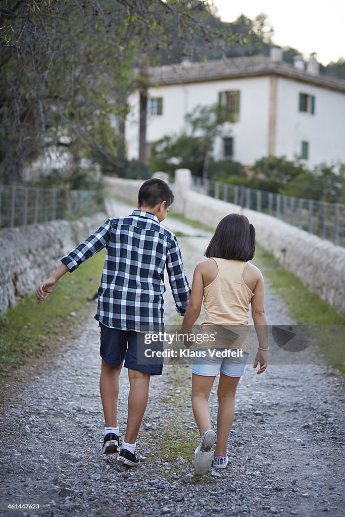 Brother and sister holding hands