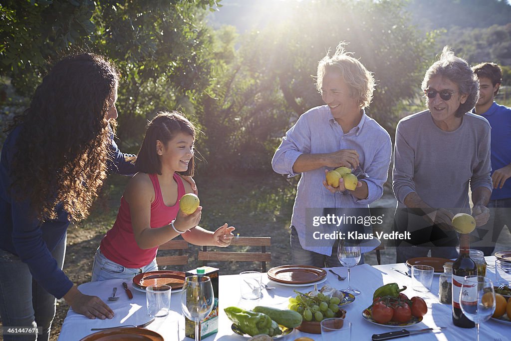 Multigenerational family preparing dining table