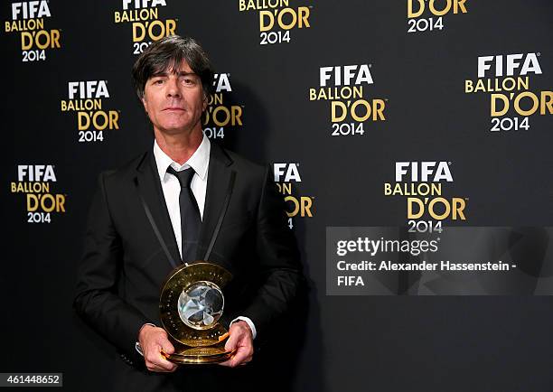 World Coach of the Year for Men's Football winner Joachim Loew of Germany poses with his award during the FIFA Ballon d'Or Gala 2014 at the...