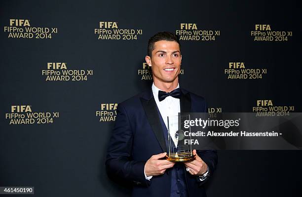 Ballon d'Or winner Cristiano Ronaldo of Portugal and Real Madrid poses with his award during the FIFA Ballon d'Or Gala 2014 at the Kongresshaus on...