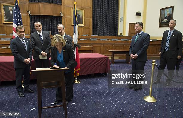 Representative Ileana Ros-Lehtinen , Republican of Florida, signs a condolence book for the people of France alongside French Ambassador to the US...