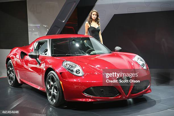 Ali Abela shows off the new Alfa Romeo 4C coupe during the media preview at the North American International Auto Show on January 12, 2015 in...