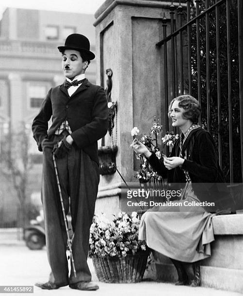 Actors Charlie Chaplin as The Tramp and Virginia Cherrill as a blind flower seller in the film 'City Lights'. /Getty Images)