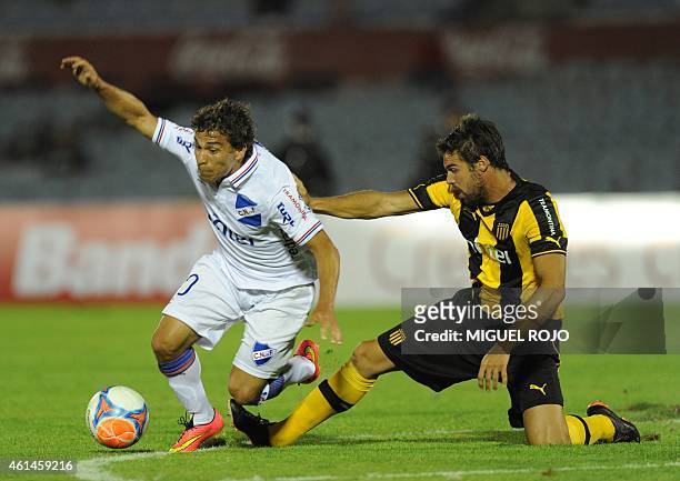Uruguayan Nacional's Sebastian Fernandez vies for the ball with Penarol's Gonzalo Viera during their Bandes Cup match at the Centenario stadium in...