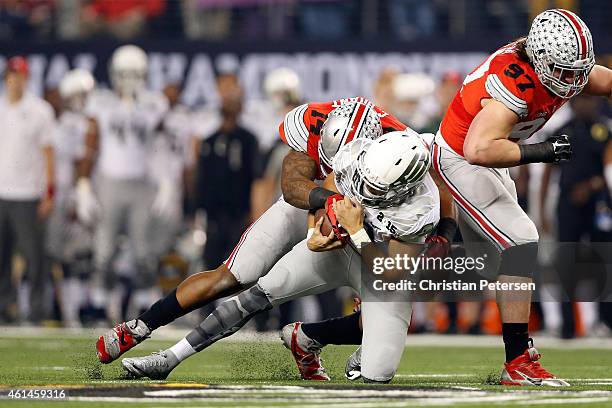 Quarterback Marcus Mariota of the Oregon Ducks gets tackled by linebacker Curtis Grant of the Ohio State Buckeyes in the first quarter during the...