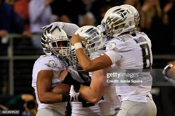 Wide receiver Keanon Lowe of the Oregon Ducks celebrates after catching a 7 yard touchdown thrown by quarterback Marcus Mariota in the first quarter...