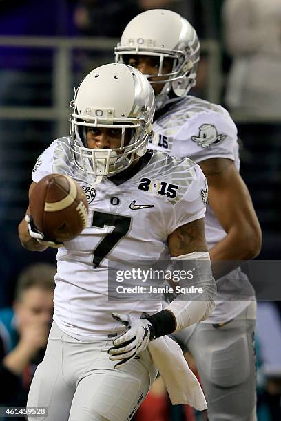 Wide receiver Keanon Lowe of the Oregon Ducks celebrates after catching a 7 yard touchdown thrown by quarterback Marcus Mariota in the first quarter...