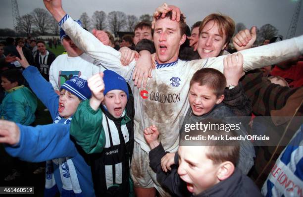 November 1994 FA Cup First Round - Enfield FC v Cardiff City, Gary Abbott celebrates victory over Cardiff with excited young Enfield fans on the...