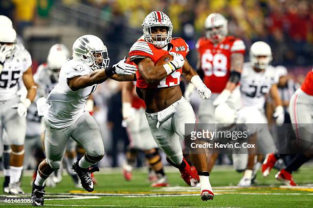 Running back Ezekiel Elliott of the Ohio State Buckeyes runs the ball 33 yards to score a touchdown in the first quarter against the Oregon Ducks...