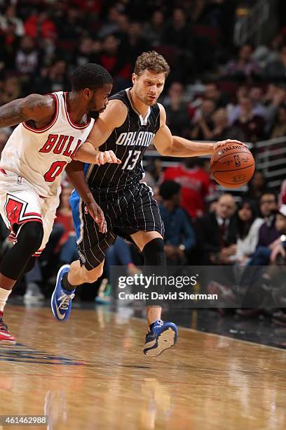 Luke Ridnour of the Orlando Magic brings the ball up court against Aaron Brooks of the Chicago Bulls on January 12, 2015 at the United Center in...