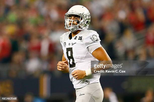 Quarterback Marcus Mariota of the Oregon Ducks looks on in the first half against the Ohio State Buckeyes during the College Football Playoff...
