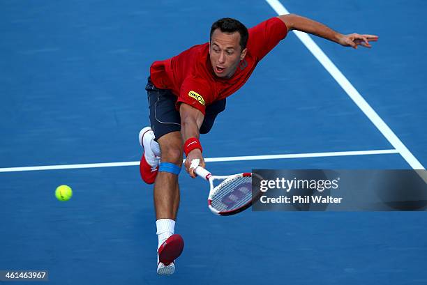 Philipp Kohlschreiber of Germany plays a backhand against John Isner of the USA during day four of the Heineken Open at ASB Tennis Centre on January...