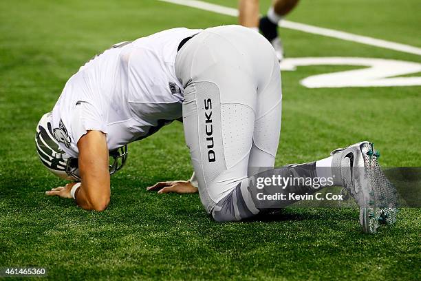 Quarterback Marcus Mariota of the Oregon Ducks kneels on the ground after a play in the fourth quarter against the Ohio State Buckeyes during the...