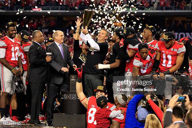 Head Coach Urban Meyer of the Ohio State Buckeyes hoist the trophy after defeating the Oregon Ducks 42 to 20 in the College Football Playoff National...