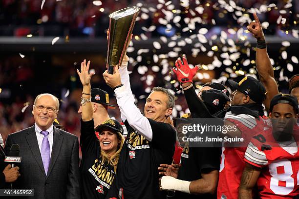 Head Coach Urban Meyer of the Ohio State Buckeyes hoist the trophy after defeating the Oregon Ducks 42 to 20 in the College Football Playoff National...