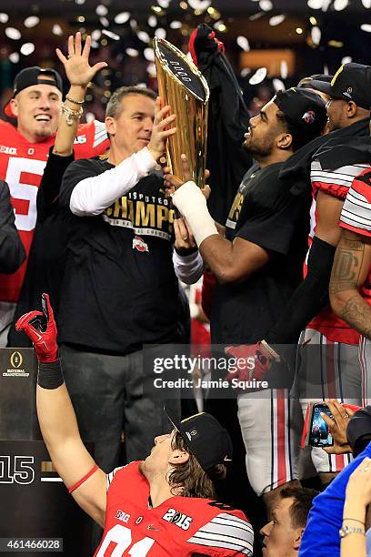 Head Coach Urban Meyer and running back Ezekiel Elliott of the Ohio State Buckeyes hoist the trophy after defeating the Oregon Ducks 42 to 20 in the...