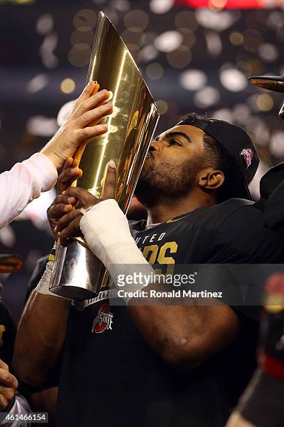 Running back Ezekiel Elliott of the Ohio State Buckeyes celebrates with the trophy after defeating the Oregon Ducks 42 to 20 in the College Football...