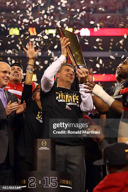 Head Coach Urban Meyer of the Ohio State Buckeyes hoist the trophy after defeating the Oregon Ducks 42 to 20 in the College Football Playoff National...