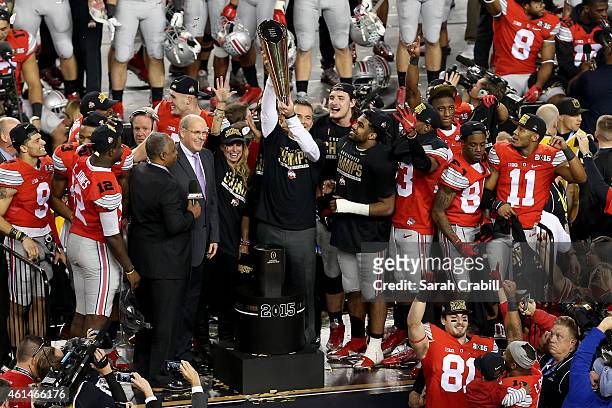 Head Coach Urban Meyer of the Ohio State Buckeyes hoist the trophy after defeating the Oregon Ducks 42 to 20 in the College Football Playoff National...