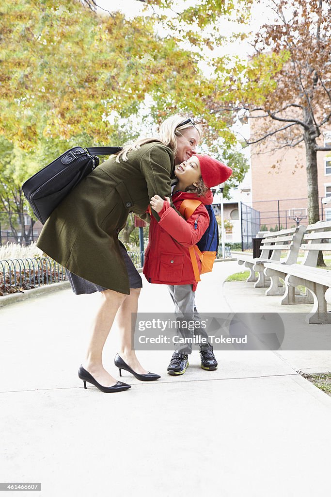 Mother and son hugging in the street