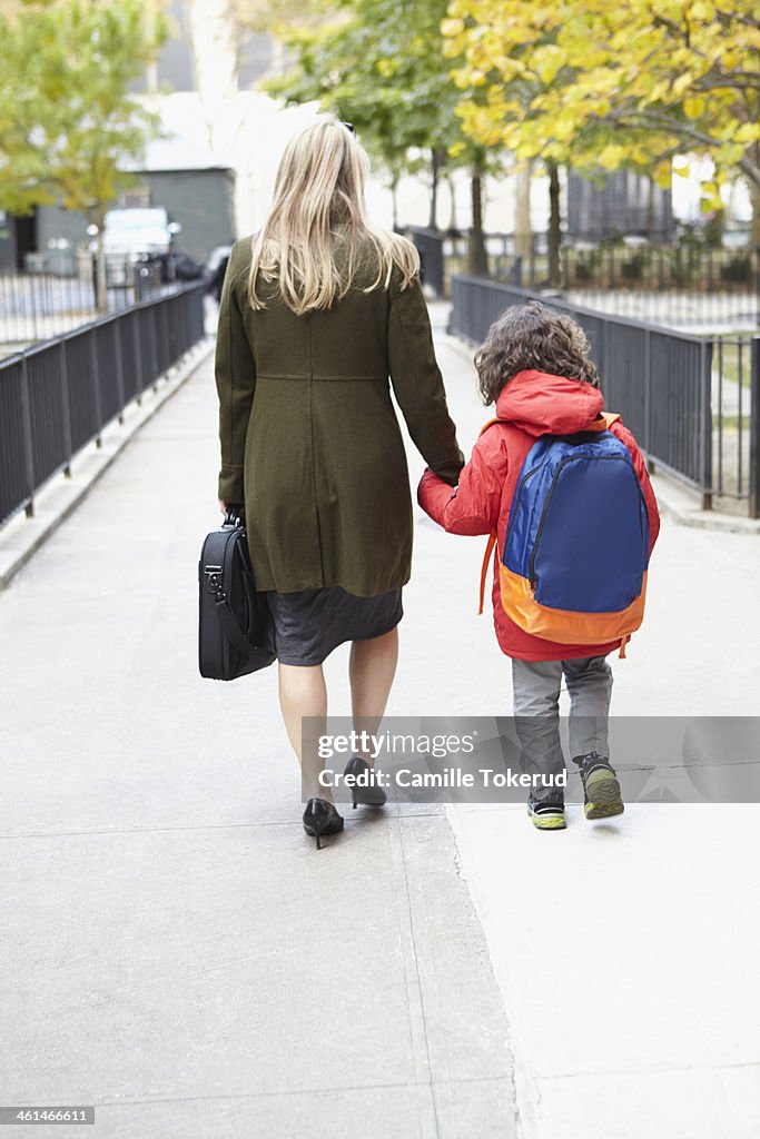 Mother taking son to school