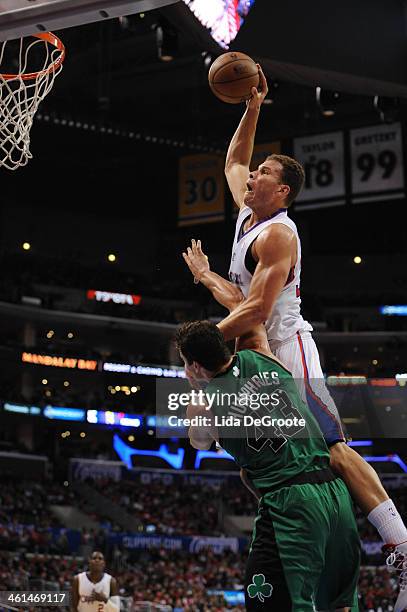 Blake Griffin of the Los Angeles Clippers dunks over Kris Humphries of the Boston Celtics at Staples Center on January 8, 2014 in Los Angeles,...