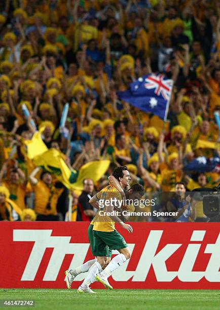 Robbie Kruse of the Socceroos celebrates scoring a goal with team mate Mathew Leckie during the 2015 Asian Cup match between Oman and Australia at...