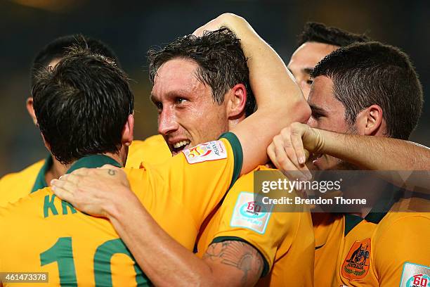 Mark Milligan of Australia celebrates with team mates after scoring a goal during the 2015 Asian Cup match between Oman and Australia at ANZ Stadium...