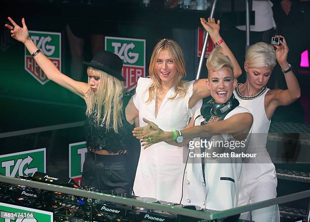 Maria Sharapova helps as Miriam Nervo and Olivia Nervo of NERVO DJ as model Kate Peck looks on as they attend the TAG Heuer Party at Ms Collins on...