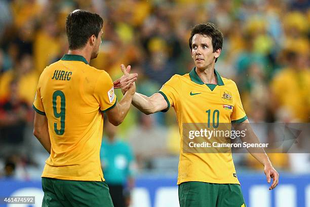 Tomi Juric of the Socceroos is congratulated by team mate Robbie Kruse after scoring a goal during the 2015 Asian Cup match between Oman and...