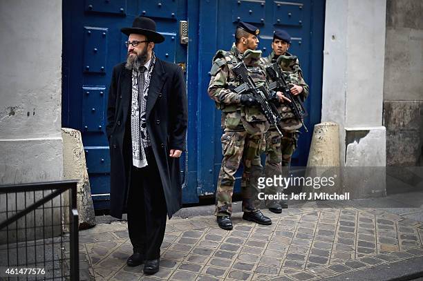 Armed soldiers patrol outside a School in the Jewish quarter of the Marais district on January 13, 2015 in Paris, France. Thousands of troops and...