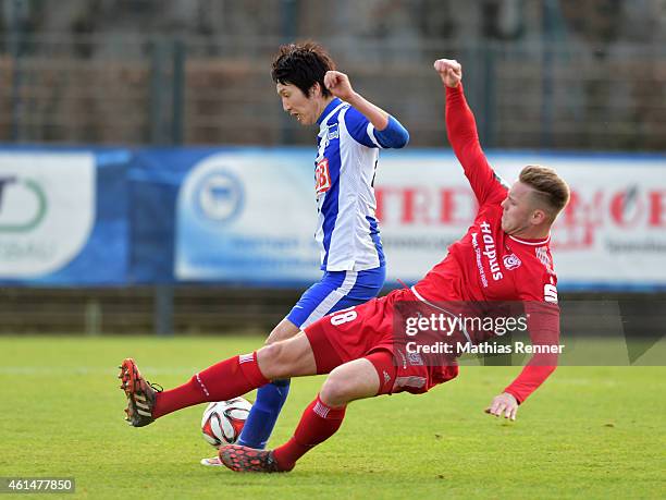 Marcel Franke of Hallescher FC tackles Genki Haraguchi of Hertha BSC during a Friendly Match between Hertha BSC and Hallescher FC on January 13, 2015...