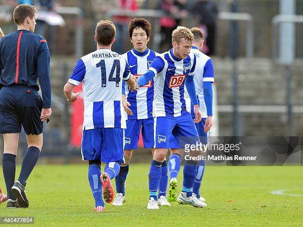 Valentin Stocker, Genki Haraguchi and Fabian Lustenberger of Hertha BSC celebrate after scoring a goal to make it 1:1 during a Friendly Match between...