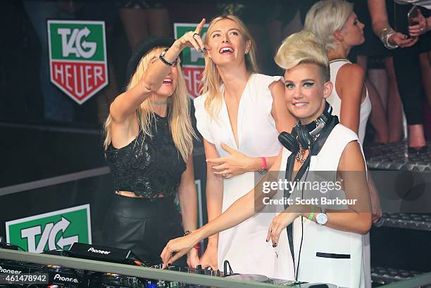 Maria Sharapova helps as Miriam Nervo and Olivia Nervo of NERVO DJ as they attend the TAG Heuer Party at Ms Collins on January 13, 2015 in Melbourne,...