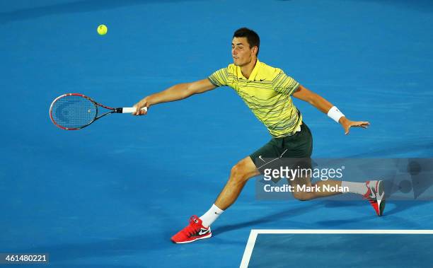 Bernard Tomic of Australia plays a forehand in his match against Alexandr Dolgopolov of the Ukraine during day five of the 2014 Sydney International...