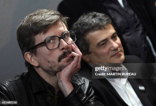 French cartoonist Renald Luzier, aka Luz, and Charlie Hebdo columnist Dr Patrick Pelloux look on as they hold a press conference to present the new...