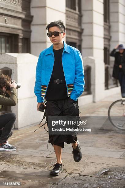 Men's Uno Style Director Declan Chan wears a Raf Simons x Sterling Ruby jacket, Craig Green shorts, Xander Zhou sneakers, and Saint Laurent...