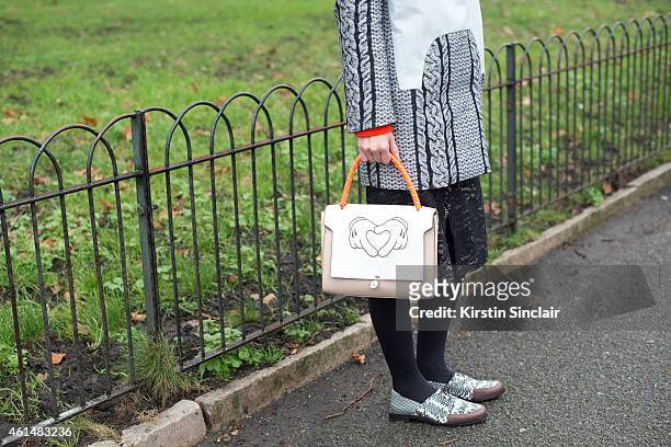 Fashion Editor for Elle China wearing Viktor and Rolf jacket, Maiyet shoes and an Anya Hindmarch bag on day 4 of London Collections: Men on January...