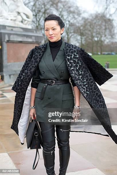 Stylist Tina Leung wearing a Louis Vuitton bag, Dior jacket, Dunhill Blazer and Maje trousers on day 4 of London Collections: Men on January 12, 2015...