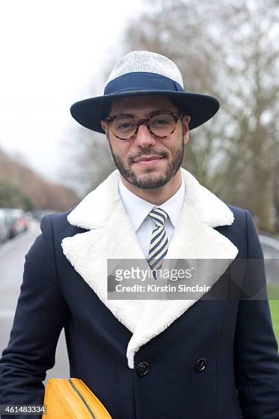 Fashion writer for I'Officiel homme Kadu Dantas wearing Gant tie, Zara jacket and hat, Louis Vuitton bag, Ricardo Almeida shirt, Ventura glasses on...