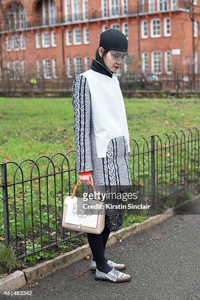 Fashion Editor for Elle China wearing an Invanka Film hat, Viktor and Rolf jacket, Maiyet shoes and an Anya Hindmarch bag on day 4 of London...